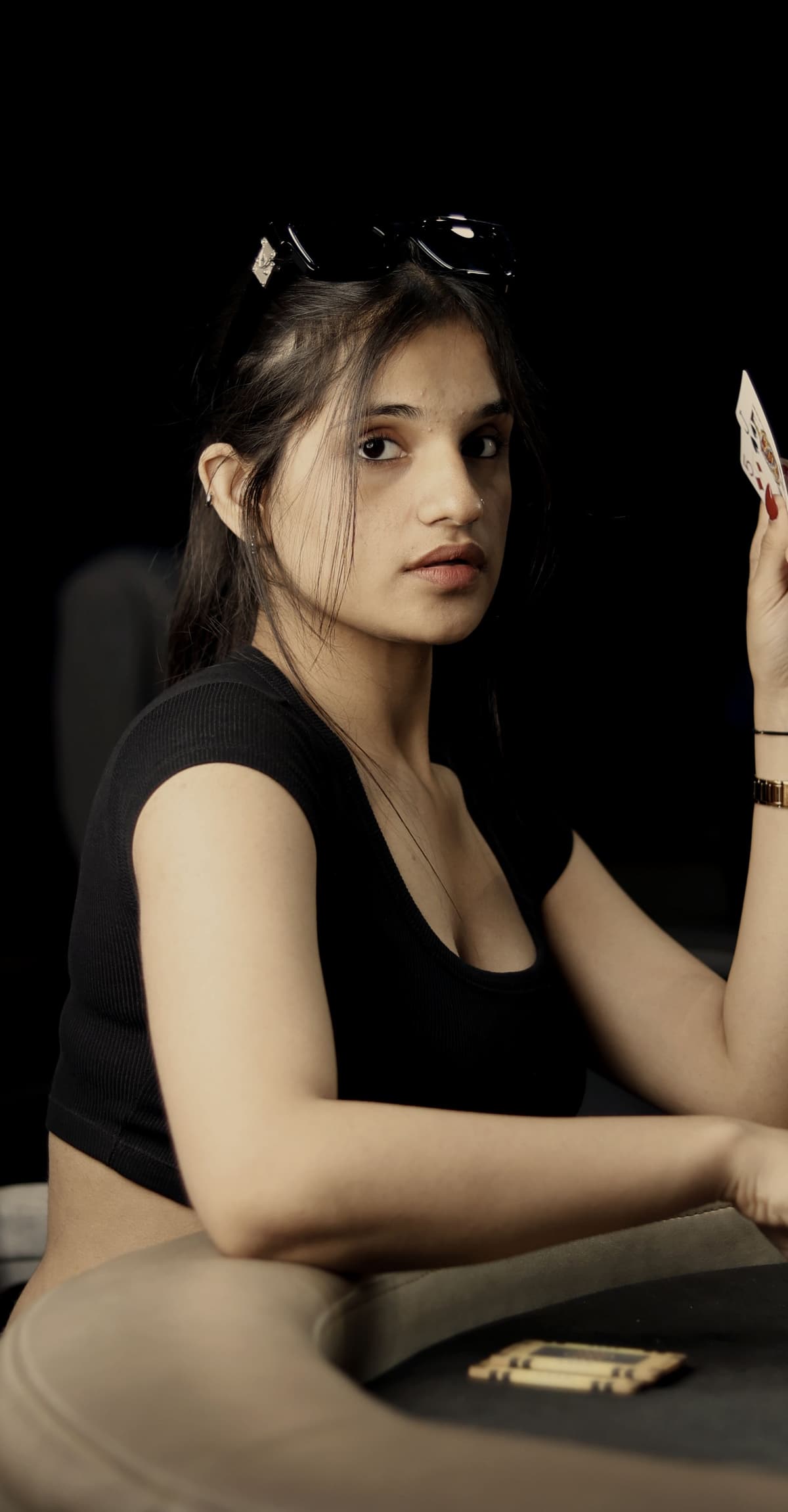 A player sitting back from the table between hands.